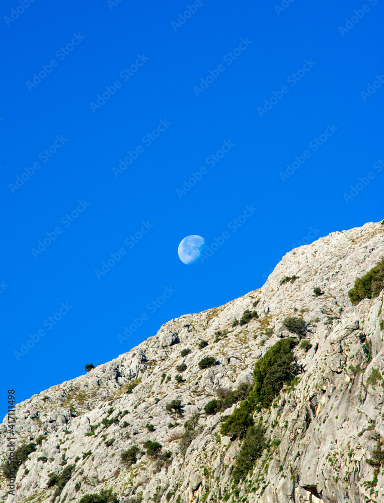 Montain landscape with the moon and blue sky Montain landscape with the moon and blue sky