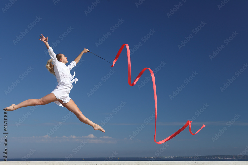 woman rhythmic gymnast with red ribbon woman rhythmic gymnast with red ribbon