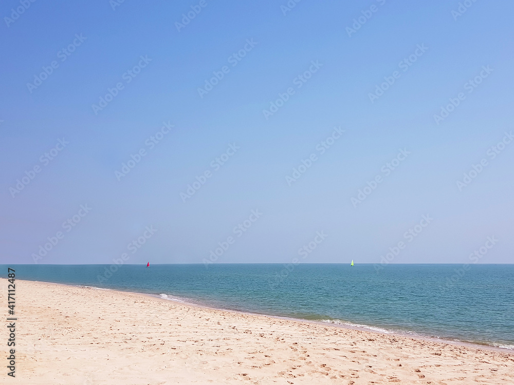 Landscape of beautiful white sand beach and sea with clear blue sky background.
