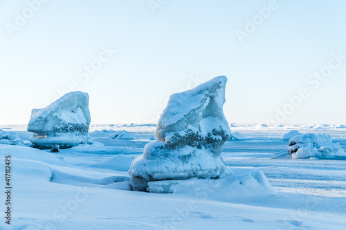 Low angle shot of ice and snow covered boulders at a beach of the baltic sea in Germany