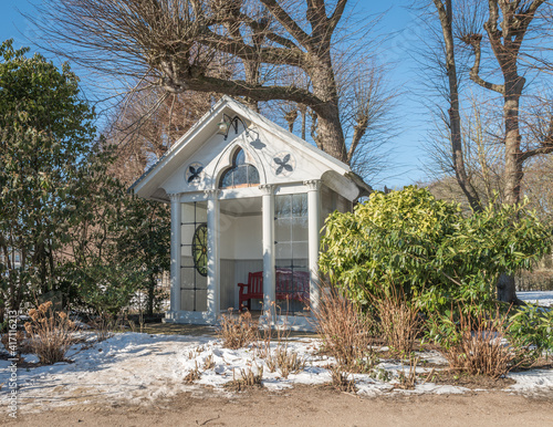 small wooden chapel with trees and snow