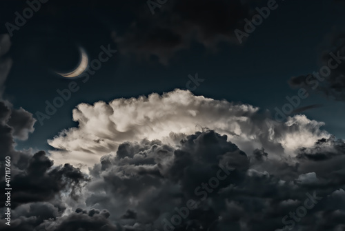 Crescent moon and clouds at night