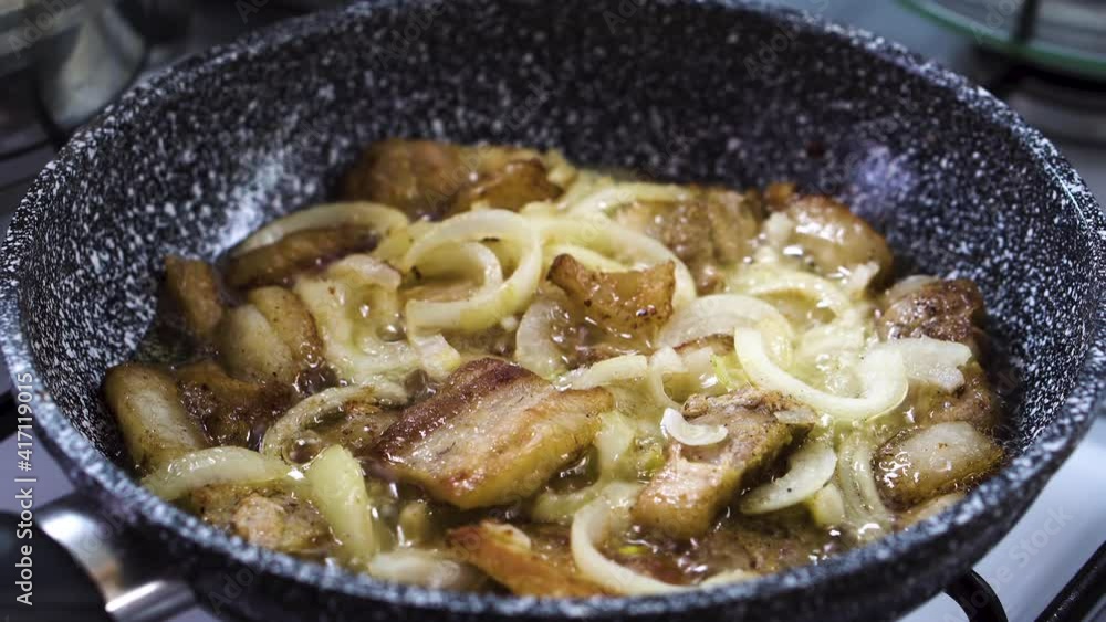 Cook fry bacon with onion on the pan. concept food Cook fry bacon with onion on the pan. concept food