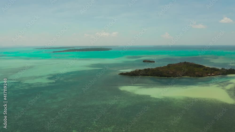 Tropical islands with coral reefs in the blue water of the sea, aerial view. Balabac, Palawan, Philippines. Summer and travel vacation concept. Tropical islands with coral reefs in the blue water of the sea, aerial view. Balabac, Palawan, Philippines. Summer and travel vacation concept.