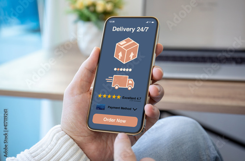 Wallpaper Mural male hands hold phone with parcel delivery application on screen Torontodigital.ca