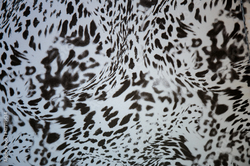 Black and white abstract camouflage. The concealment pattern on a fabric. Conception of winter masking.