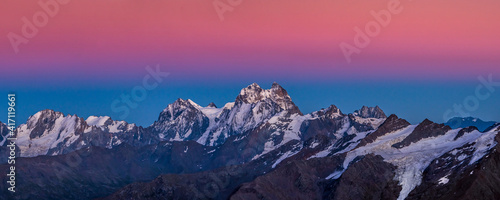 Snowy Greater Caucasus ridge with the Mt. Ushba after sunset. Panoramic view from 