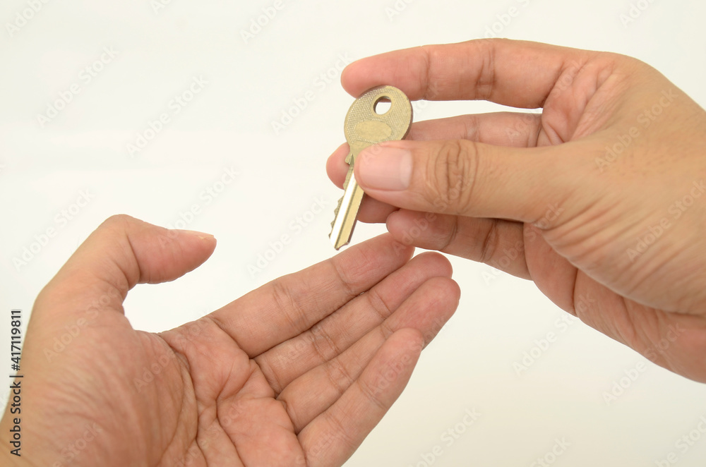 hand holding a key, symbolic for success, open new world , conceptual