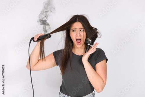 girl with damaged hair unhappy dry hair ends and iron burning smoke, damaged cut bad hair concept