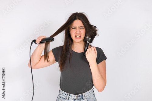 girl with damaged hair unhappy dry hair ends and iron burning smoke, damaged cut bad hair concept