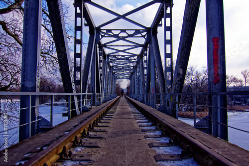 an abandoned railway bridge over a frozen river