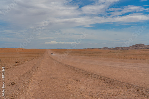 Landscape with road and a car at Namib-Naukluft National Park   s a national park of Namibia