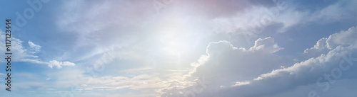 White clouds and morning sun on blue sky panoramic background
