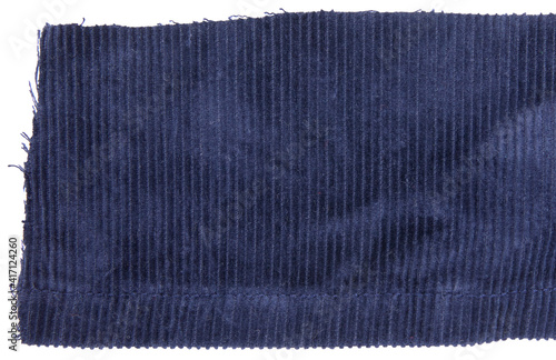 Blue cotton traditional corduroy retail, with tattered around, against white background photo