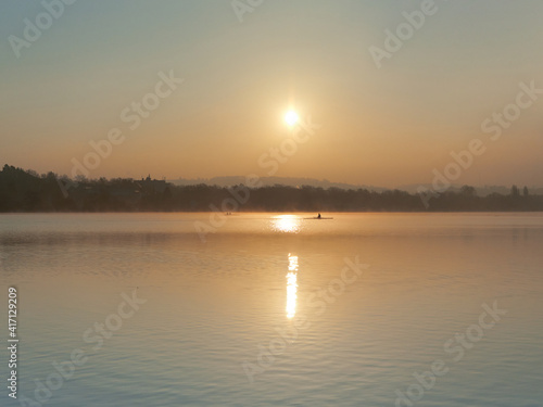 Vászonkép The beautiful landscape of Lake Baldeneysee just after sunrise with the rowers in the background