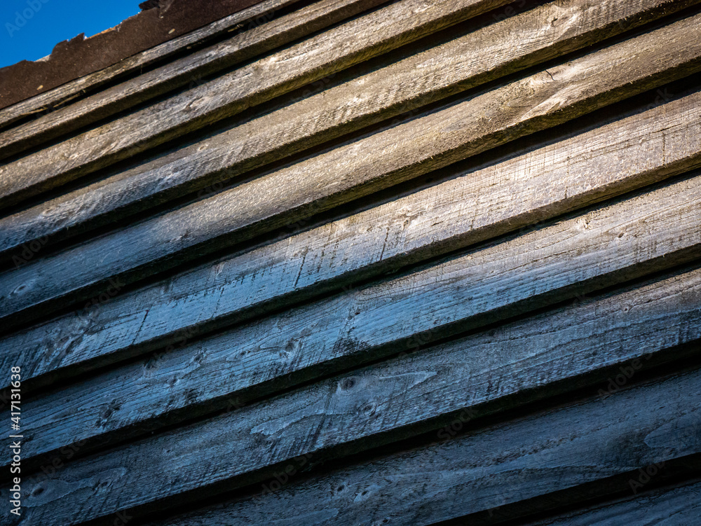 Weathered wooden panels at the edge of a roof 