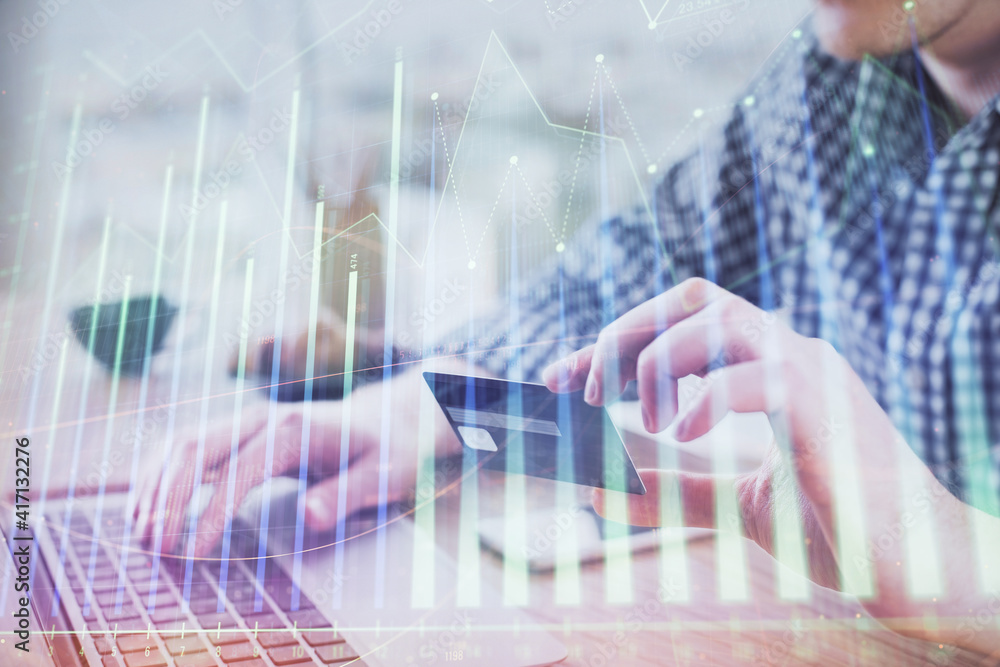 Double exposure of man hands holding a credit card and Forex graph drawing. Stock trading and digital fintech in Internet E-commerce concept. Double exposure of man hands holding a credit card and Forex graph drawing. Stock trading and digital fintech in Internet E-commerce concept.