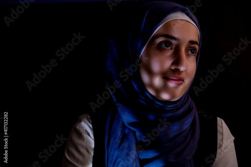 portrait of middle eastern girl in a dark room