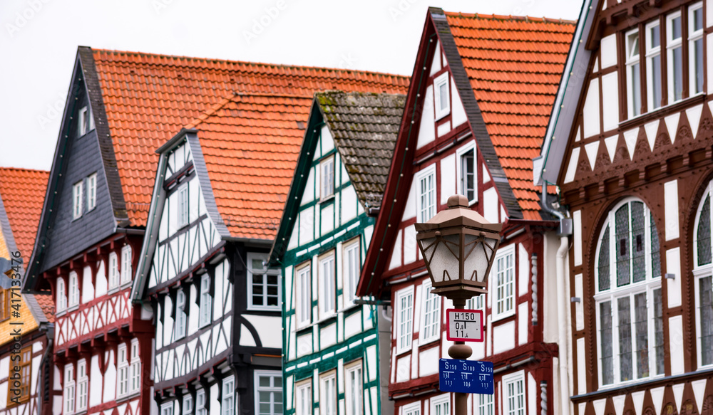 Focus on the lamppost and old Germany architecture background. German houses.