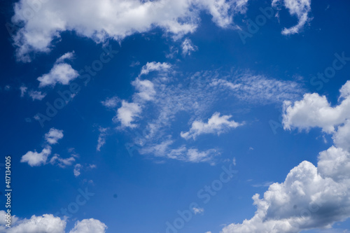 Bright cumulus clouds against a blue sky.