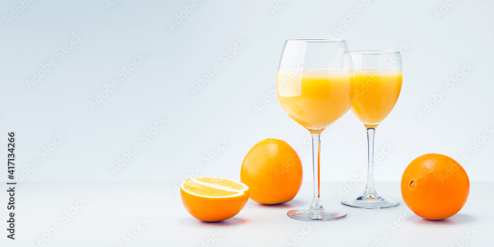 Two glasses of orange juice and fruits with copy space.