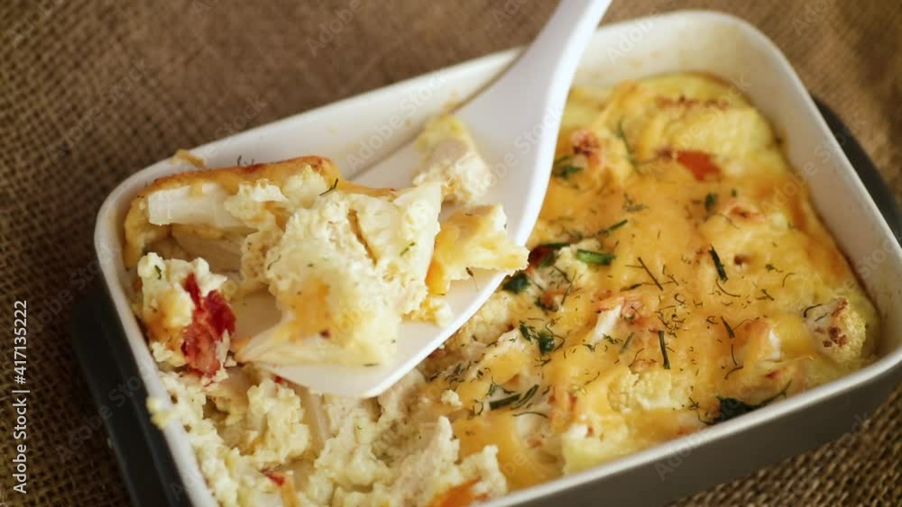 baked cauliflower with chicken fillet and vegetables topped with cheese baked cauliflower with chicken fillet and vegetables topped with cheese