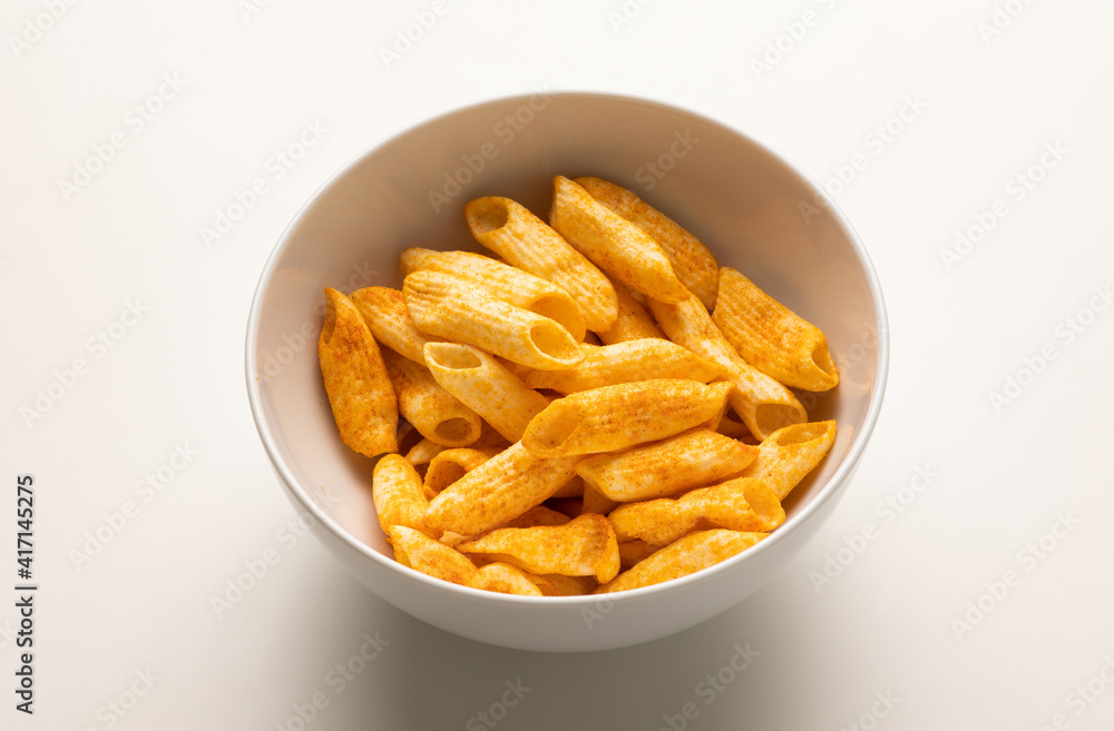 Crispy penne pasta shaped salty. Fast food or junk food snacks unhealthy concept. Crispy penne pasta shaped salty. Fast food or junk food snacks unhealthy concept.