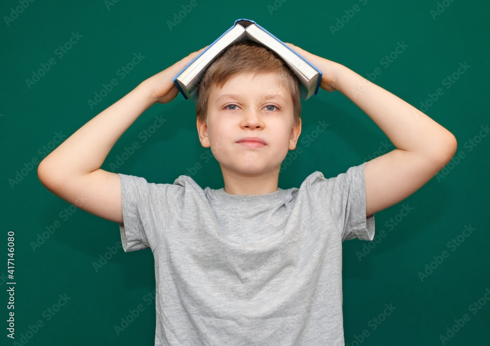 Boy child with an open book in his hands Boy child with an open book in his hands