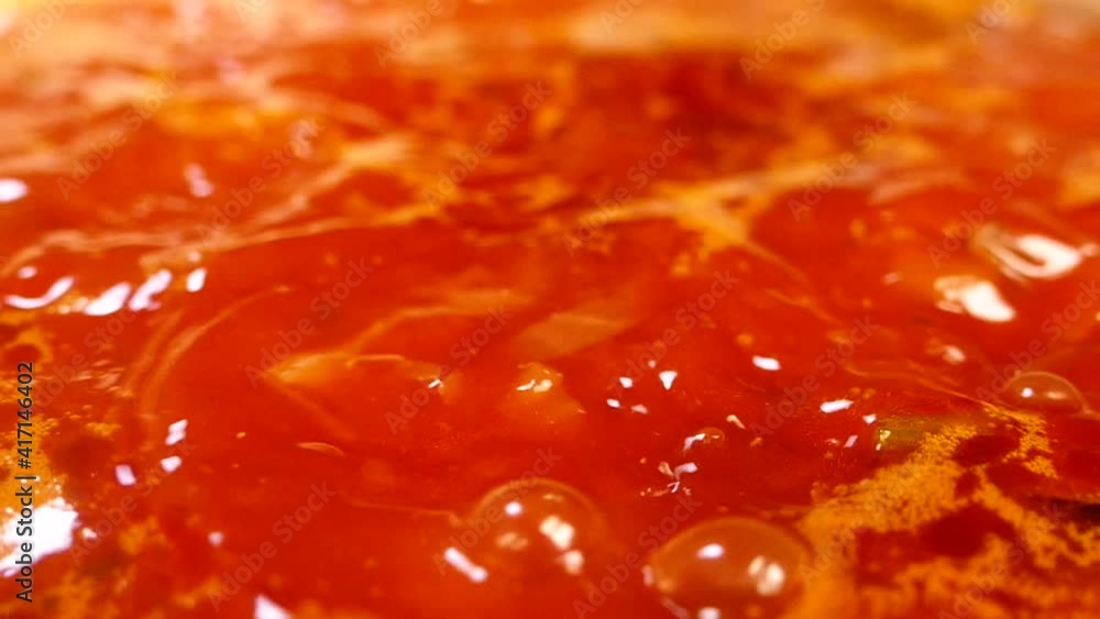 Liquid red dish boils in a pan. Ukrainian borsch. Stew with vegetables and table beets and carrots. Liquid red dish boils in a pan. Ukrainian borsch. Stew with vegetables and table beets and carrots.