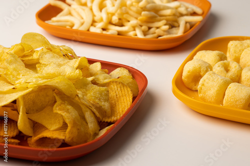 Many Crispy Snacks food potato chip salty. Fast food or junk food snacks unhealthy concept.