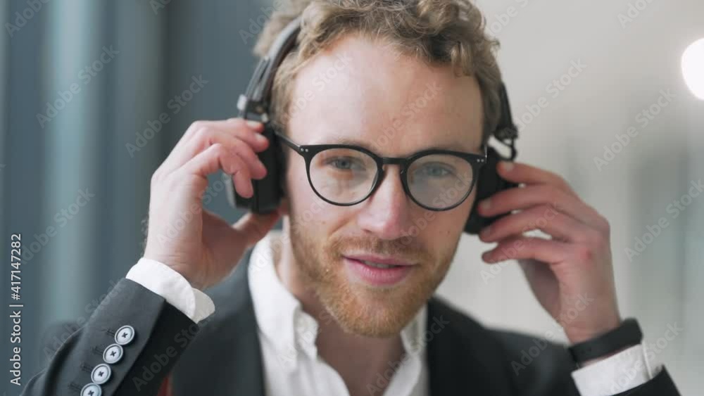 Portrait of a stylish young man in headphones and glasses Portrait of a stylish young man in headphones and glasses