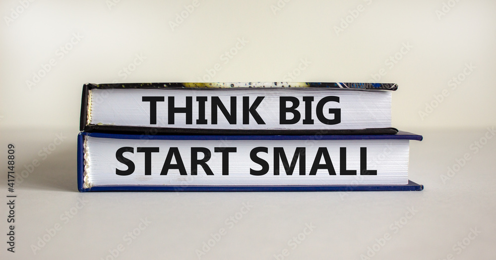 Think big start small symbol. Concept words 'Think big start small' on books on a beautiful white background. Business, motivational and think big start small concept.