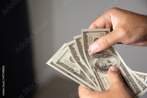 Close up male hand Counting money us dollar. Financial business concept.