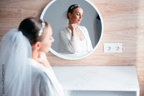 Bilde på lerret Stunning bride in lingerie sitting at dressing table