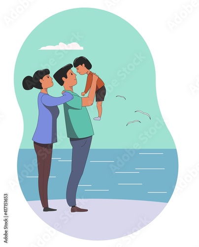 A young family, a man and a woman walks with a small child along the embankment of the sea. Family vacation in nature.