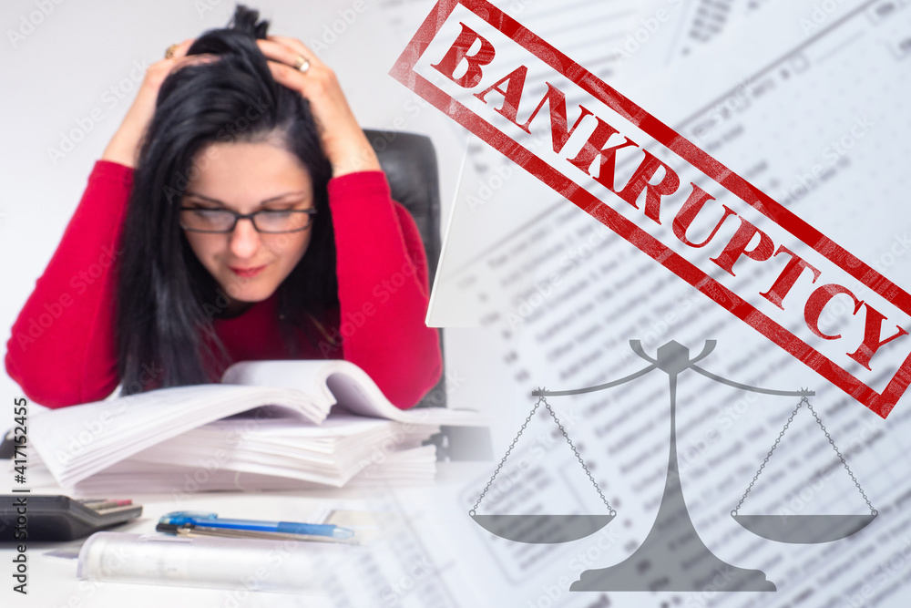 Bankrupt. Businesswoman next to bankruptcy inscription. Girl is holding on to her head. Bankruptcy due to financial problems. Concept - bankruptcy law. Businesswoman lost business. Company ruin Bankrupt. Businesswoman next to bankruptcy inscription. Girl is holding on to her head. Bankruptcy due to financial problems. Concept - bankruptcy law. Businesswoman lost business. Company ruin