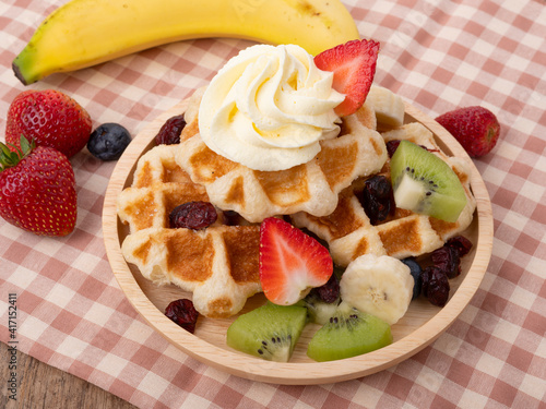 Plate of waffles with  fresh  fruits
