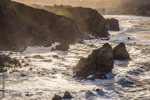 Atlantic Ocean rocky shore seen from Gaztelugatxe island in Spain photo