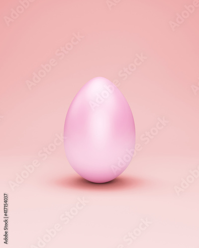 Painted easter egg on pink studio background