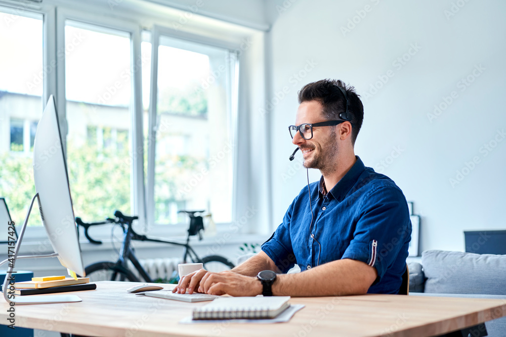 Cheerful consultant working at home Cheerful consultant working at home