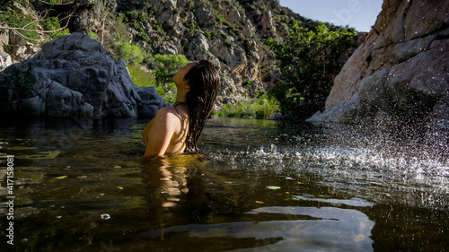 Young girl flipping hair in Mojave river