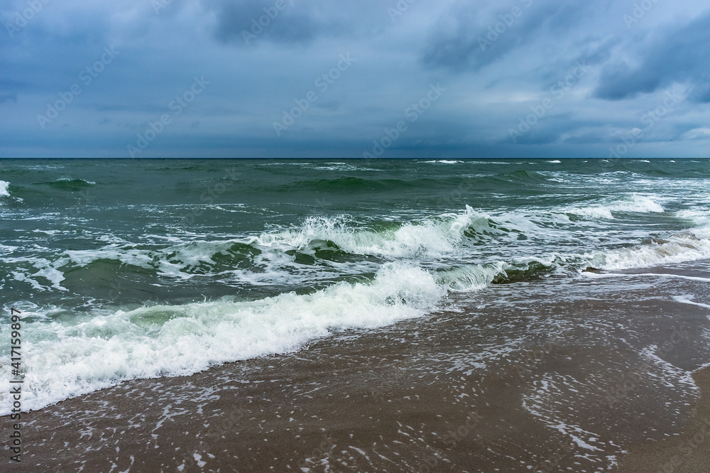 The sea is agitated. Huge waves of the sea. Cloudy landscape on the sea.