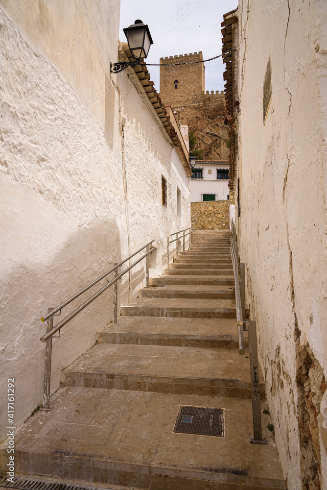 Obraz premium Stone stairs leading to the medieval castle placed on the top of hill above the historic town of Almansa on a sunny summer day, Albacete, Spain