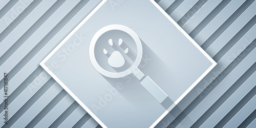 Paper cut Paw search icon isolated on grey background. Magnifying glass with animal footprints. Paper art style. Vector.