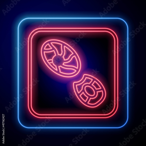 Glowing neon Human footprints shoes icon isolated on black background. Shoes sole. Vector.