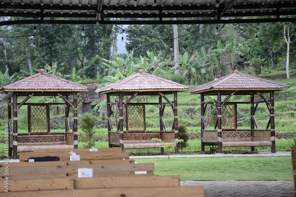 traditional design of gazebo made of wood in garden