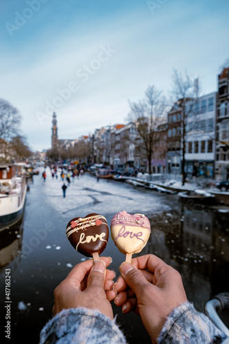 Photography love romantic ice cream with on the background people ice skating at the frozen canals of Amsterdam, Valentine Romantic concept
