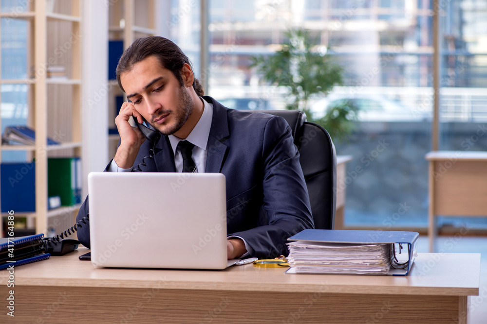 Young businessman employee working in the office Young businessman employee working in the office
