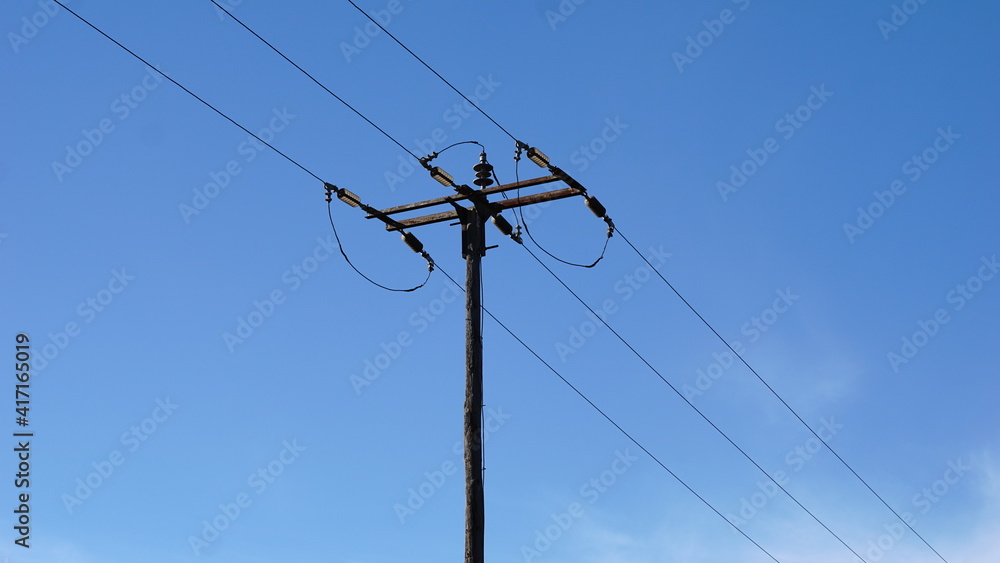 electrical post with power lines against sky electrical post with power lines against sky