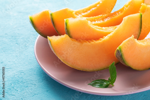 Slices of juicy cantaloupe melon on a plate.